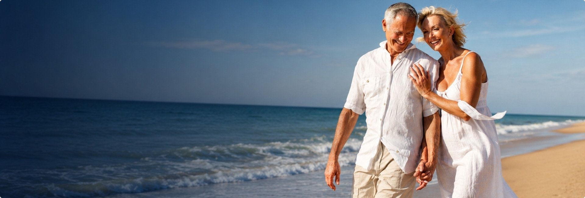 Mature couple enjoying a beach holiday by the sea
