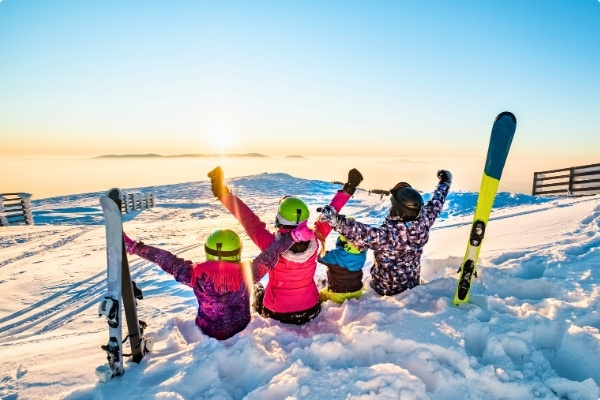 Family on moutain enjoying winter sports travel insurance