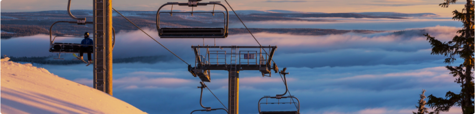 Skiers on a mountain slope in a European ski resort – Winter Sports Travel Insurance cover example