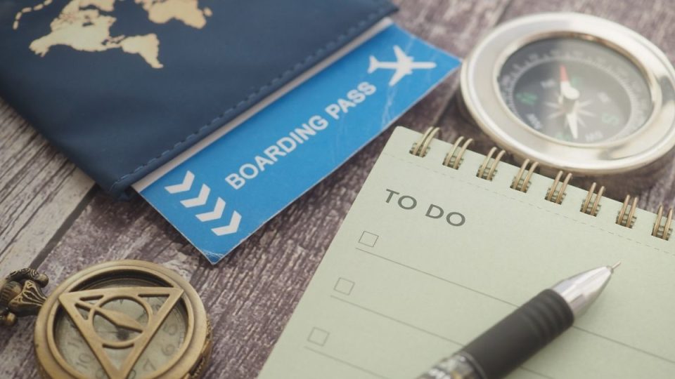 Traveller preparing for a European holiday with passport, boarding pass and travel checklist